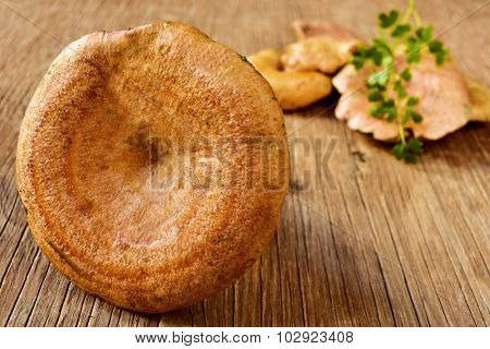 some rovellons, typical autumn mushroom of Spain, on a rustic wooden table