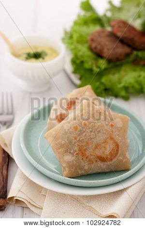 burrito wraps or tortilla wrapped with meat and beans and served on a plate