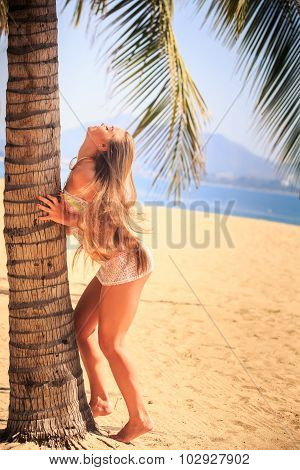 Blonde Girl In Lace Touches Palm Wind Lifts Long Hair Upwards