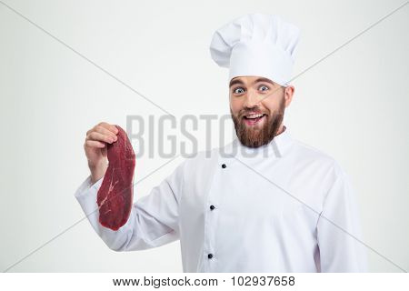 Portrait of a happy male chef cook holding meat isolated on a white background