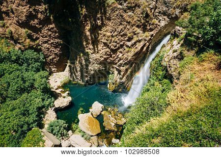 Waterfall under New Bridge - Puente Nuevo in Ronda, Spain