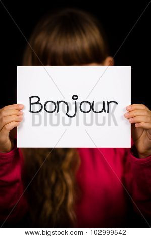 Child Holding Sign With French Word Bonjour - Hello