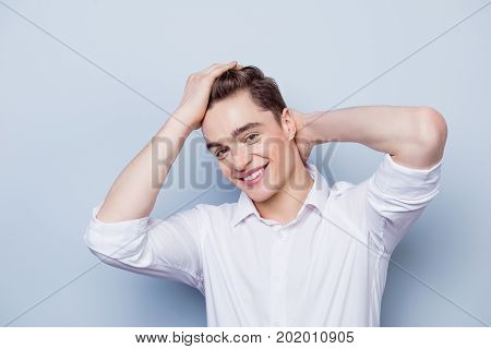 Portrait Of Happy With Beaming Smile Young Guy Dressed In White Shirt With Rolled Sleeves  Posing Ag