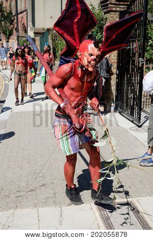 London United Kingdom - August 27 2017. Notting Hill Carnival one of the largest street parties in Europe is now in its 51st year. This year was close to the ruin of Grenfell Tower scene of a devastaing fire.