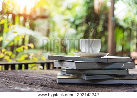 diary and coffee mug on the floor with wooden light into the top left corner.