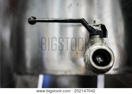 a close-up of an oilve oil container tap