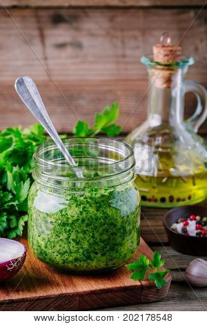 Traditional Green Chimichurri Sauce With Fresh Parsley, Red Onion, Garlic, Olive Oil In Glass