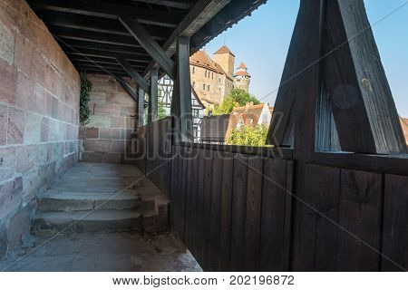 The Castle Of Nuremberg In The Afternoon Sun From The Guards Walkway With A Wooden Roof