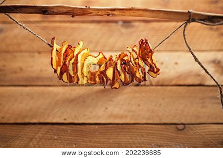 Dried apple slices and wooden backdrop