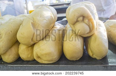 Churros preparation at Churros shop or churreria. Raw dough big pieces