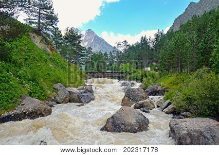 River and waterfall in forest, mountains of Caucasus, Russia.