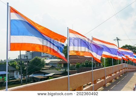 Close Up. Thai Flags On The Pole Blown By Wind At The Bridge.