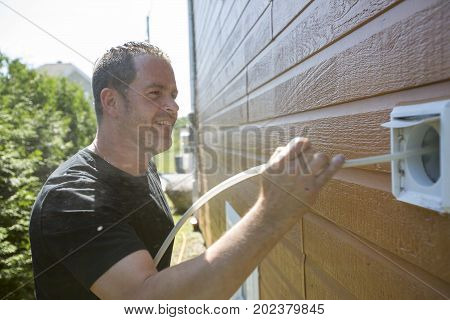A ventilation cleaner man at work with tool