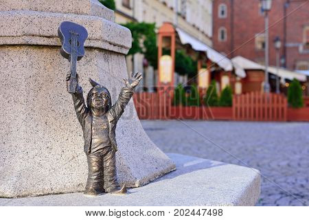 WROCLAW POLAND - JUNE 2017: Wroclaw a miniature statue of a gnome on the main square of the city. A dwarf with a guitar. The concept of music.
