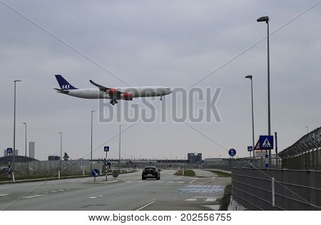 Copenhagen Denmark - April 25 2017: Landing plane very close to touchdown in Copenhagen Airport in Denmark