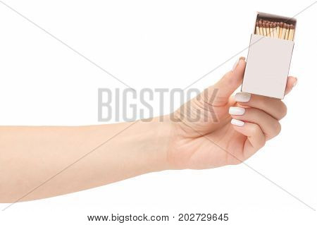 Female hand holding a box of matches on a white background isolation