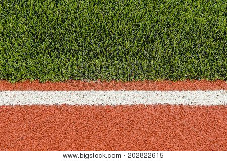 Detail of running track rubber lanes with the artificial grass.