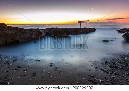Toroii Japanese shrine gate sunrise at sea Oarai city , Ibaraki Japan