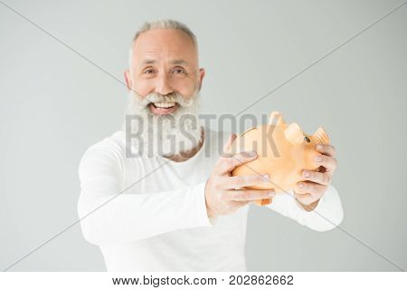Senior Man With Piggy Bank