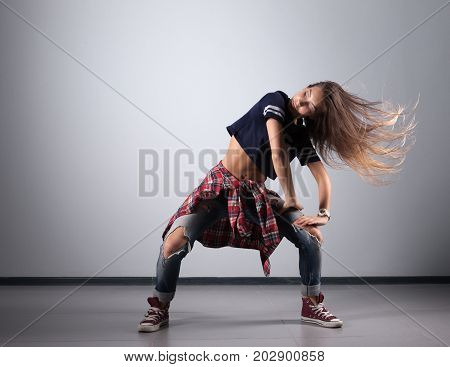 modern young beautiful dancer posing on a white studio background