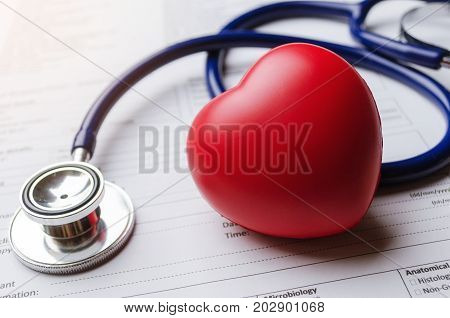 close up stethoscope red heart and patient information form on desk heart healthcare technology medical diagnosis medical report record and history patient concept selective focus vintage tone