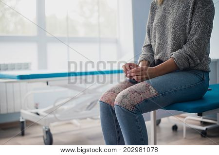 Woman's hand waiting for doctor in hospital feeling worried
