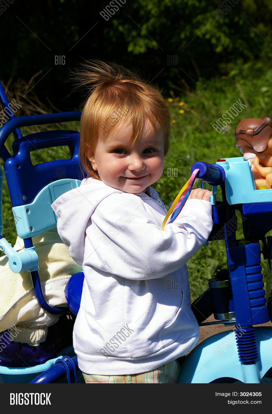 girl riding tricycle
