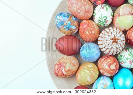 A Large Set Of Easter Eggs On A Large Wooden Plate, Copy Spce, Bright Colors, High Contrast, Festive