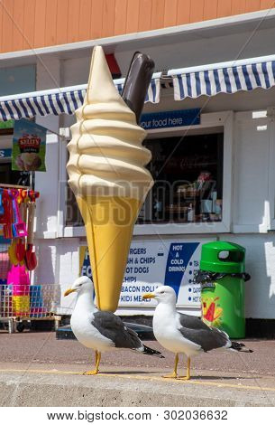 Clacton  Essex United Kingdom  -10 May 2019: Large Plastic Icecream In Front Of Shop With Seagulls S