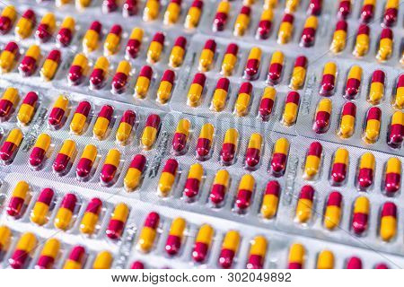 Antibiotic Capsule Pills In Blister Pack At Production Line Of Pharmaceutical Manufacturing Factory.