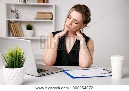 Woman In Office Massaing Her Neck. Sick Female Worker.