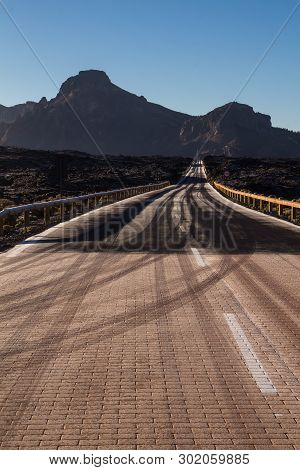 High Quality Of The Roads In Teide National Park. Roads Lined By Tuf Stones And Mountains. Thin Laye