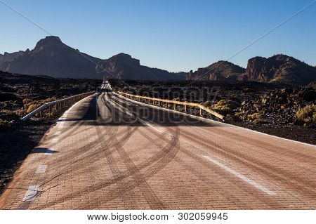 High Quality Of The Roads In Teide National Park. Roads Lined By Tuf Stones And Mountains. Thin Laye