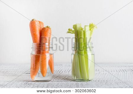 Fresh Carrot And Celery In Mason Jar With Water. Save Summer Harvest. Storage. Zero Waste.