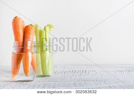 Fresh Carrot And Celery In Mason Jar With Water. Save Summer Harvest. Storage. Zero Waste.