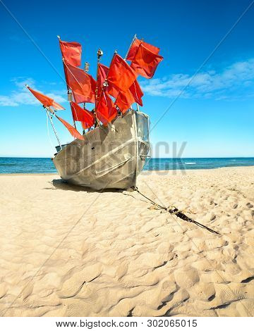 Traditional Fisherman Boat On A Sandy Shore Of The Baltic Sea. Baabe Willage, Island Rugen, Germany