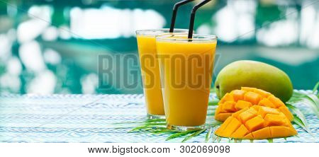 Fresh Tropical Fruit Smoothie Mango Juice And Fresh Mango On A Outdoor Tropical Background. Copy Spa