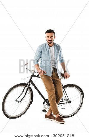 Serous Bearded Man With Bicycle Looking At Camera Isolated On White