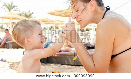 Closeup Portrait Of Happy Family Adorable 3 Years Old Toddler Boy Relaxing On Beach And Applying Uv 