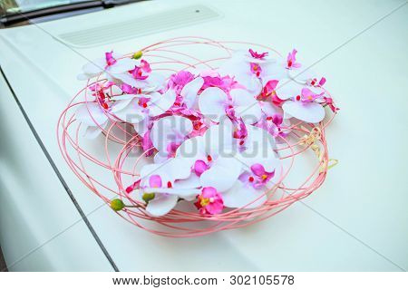 Orchids On A Wedding Car. Composition Of White Orchids On A White Car