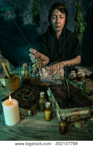 Dark Witch At Work: Black Magic Woman Makes The Witchery By Mixing Herbs, Casting The Spells, Runnin