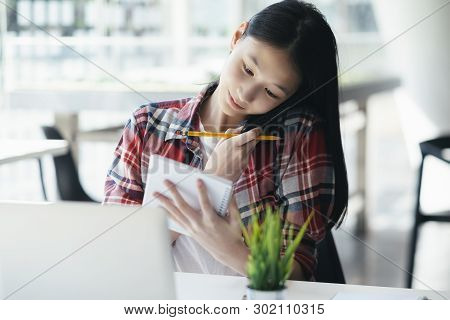 Young Office Woman Talking On Mobile Phone With Client.