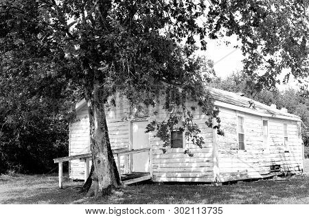 Old, Shabby, Abandoned, Neglected House Located In A Rural Country Setting That Needs Repair, B&w