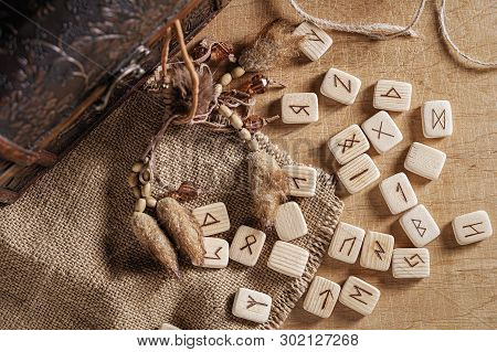 Handmade Scandinavian Wooden Runes On A Wooden Vintage Background. Concept Of Fortune Telling And Pr
