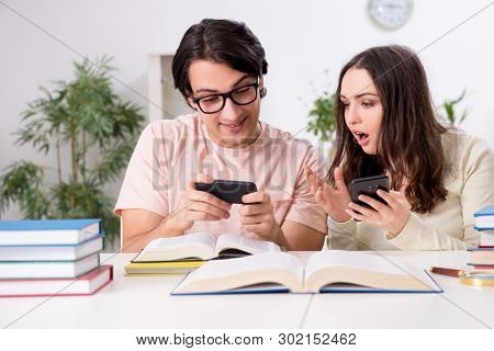 Students preparing for exam together at home 