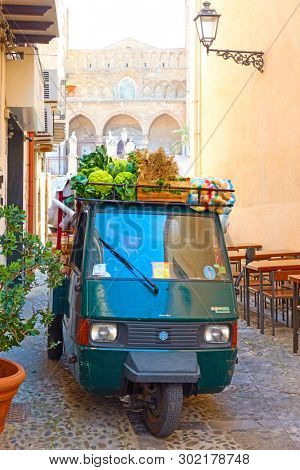 Cefalu, Italy - March 19, 2019: Mobile shop of greengrocer in the street in the Old Town of Cefalu