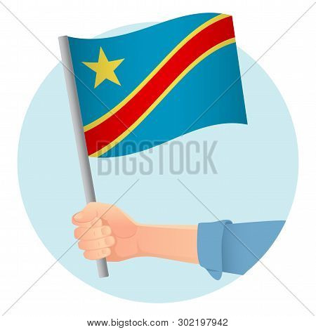 Democratic Republic Of The Congo Flag In Hand. Patriotic Background. National Flag Of Democratic Rep