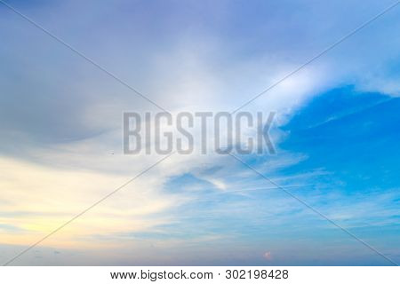 Soft Pastel Color Silky Cloud Mixing With Dark Grey Cloud On Blue Sky During Sunrise