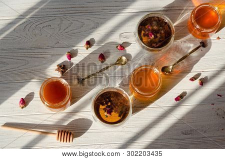 Composition With Honey, Tea And Tea Accessories On A White Wooden Background.