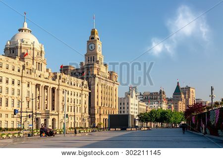 Shanghai, China - May, 2019: Old Buildings On The Bund With Iron Bull Statue In Front Of Chinese Ban